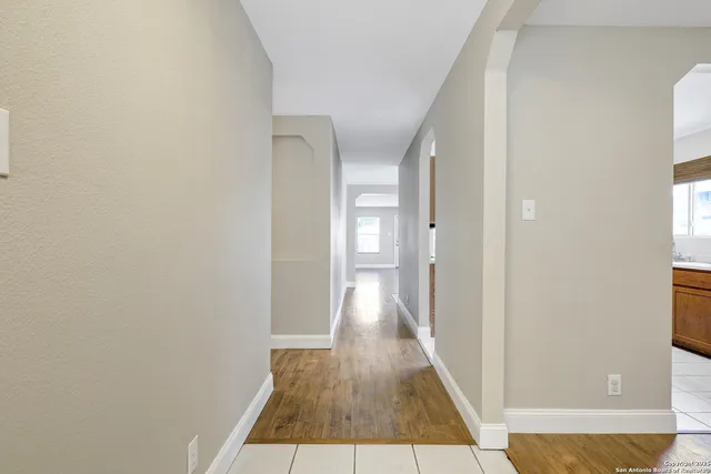 a view of a hallway with wooden floor