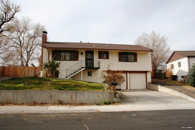 885 Reeves Avenue Reno, NV 89503 - Photo 1 of 1 a view of a white house with large windows next to a road