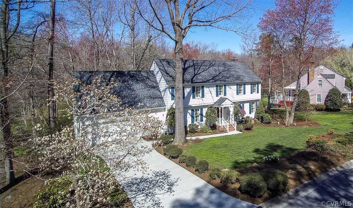 a view of house with yard and green space