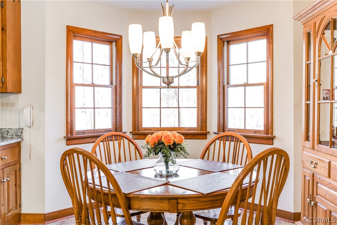 14302 Chimney House Road Midlothian, VA 23112 - Photo 16 of 50 a view of a dining room with furniture a chandelier and wooden floor