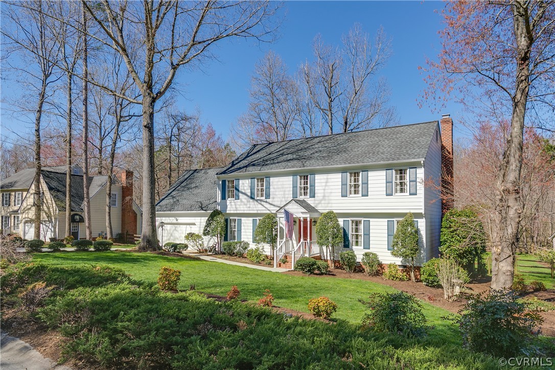 14302 Chimney House Road Midlothian, VA 23112 - Photo 48 of 50 a front view of a house with a yard table and chairs
