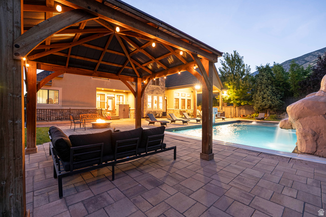 687 South 2080th Street East Springville, UT 84663 - Photo 146 of 149 Expansive outdoor living area featuring a wood-beam pergola, string lighting, and a fire pit