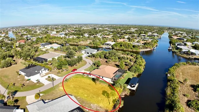 an aerial view of residential houses with outdoor space and swimming pool