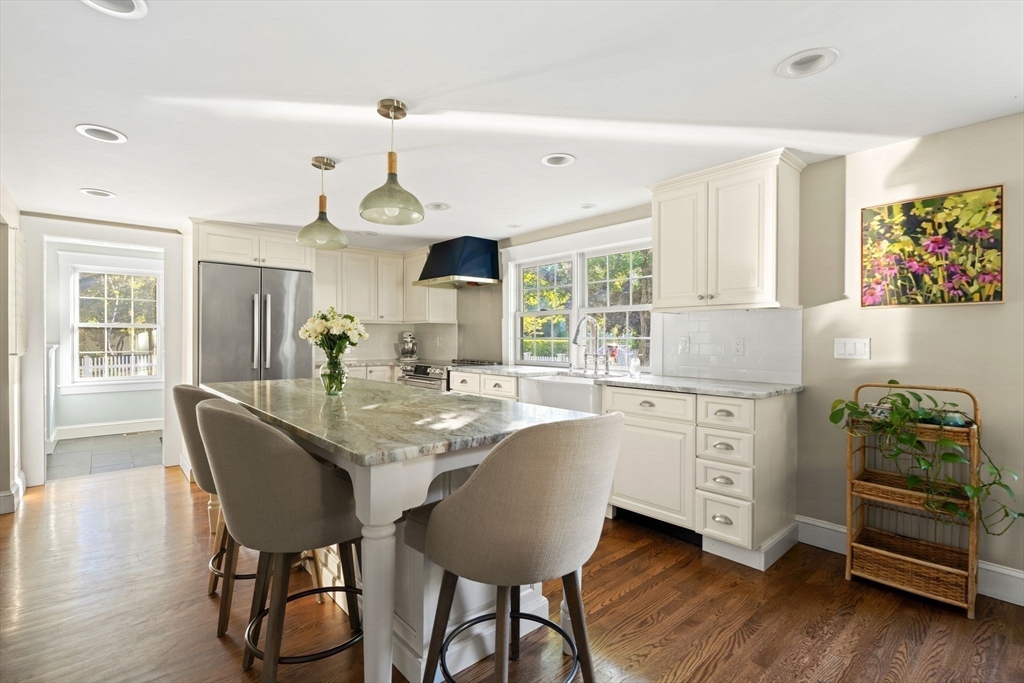 4 Windemere Park Extension Manchester, MA 01944 - Photo 5 of 41 a kitchen with granite countertop white cabinets and stainless steel appliances