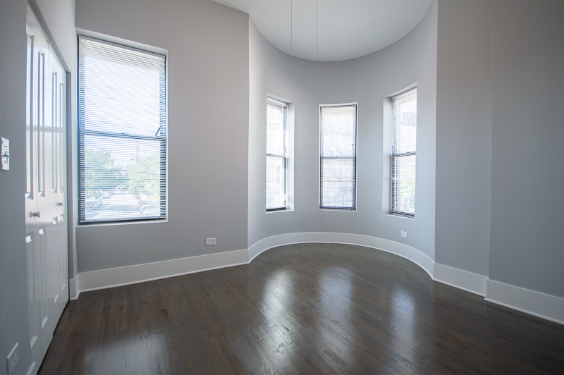 1044 West 18th Street, Unit 3F Chicago, IL 60608 - Photo 5 of 8 a view of an empty room with wooden floor and a window