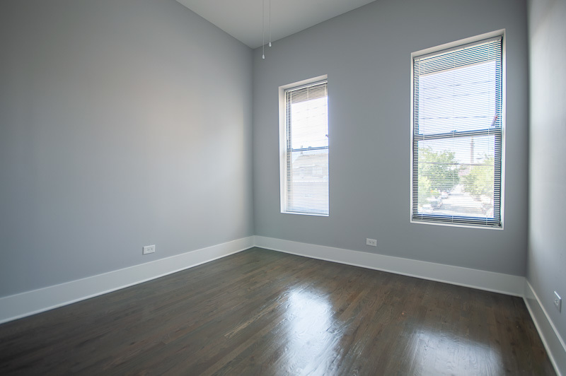 1044 West 18th Street, Unit 3F Chicago, IL 60608 - Photo 6 of 8 an empty room with wooden floor and windows