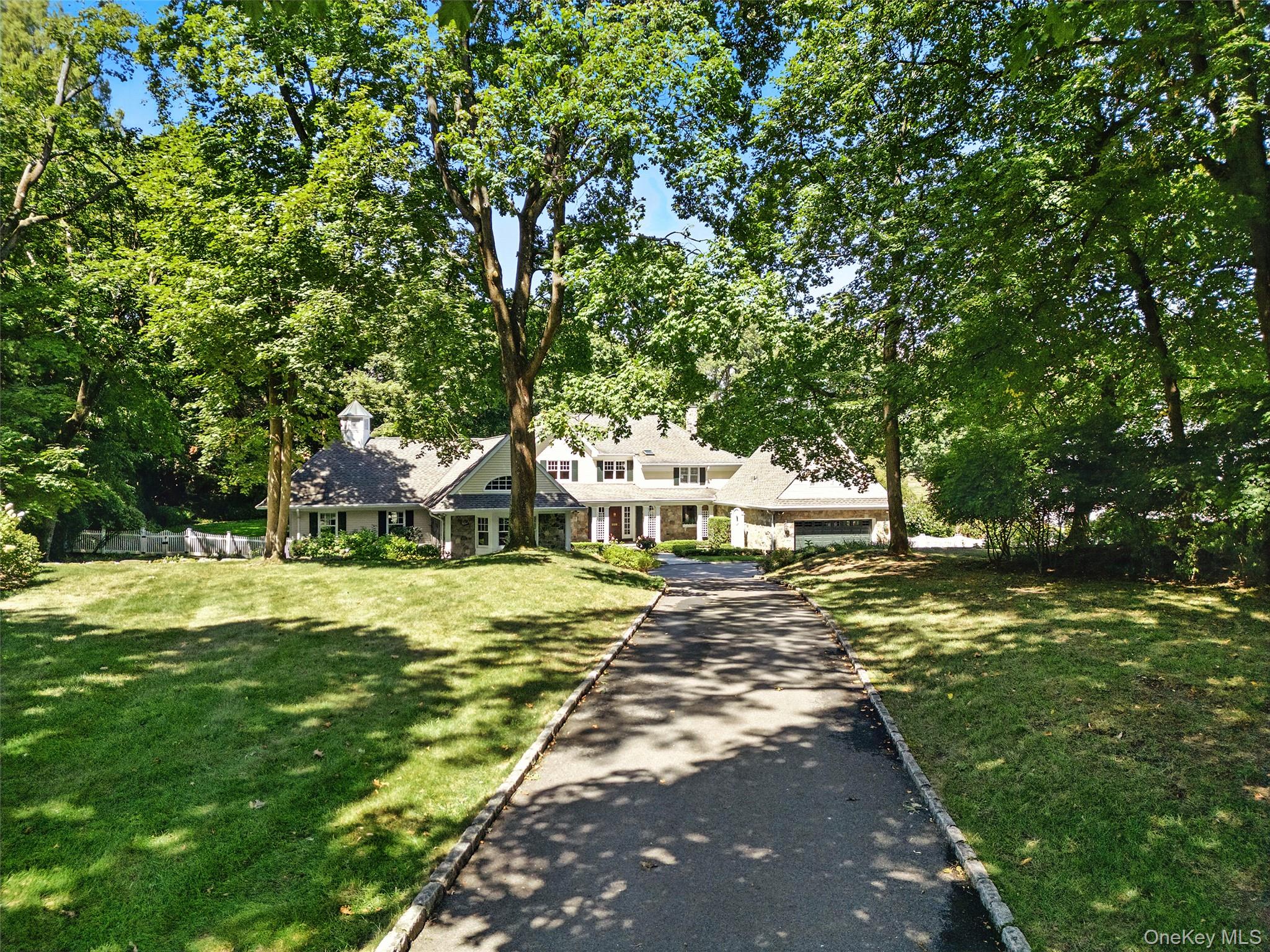 9 Boxwood Lane Rye, NY 10580 - Photo 1 of 1 a view of a house with a big yard and large trees