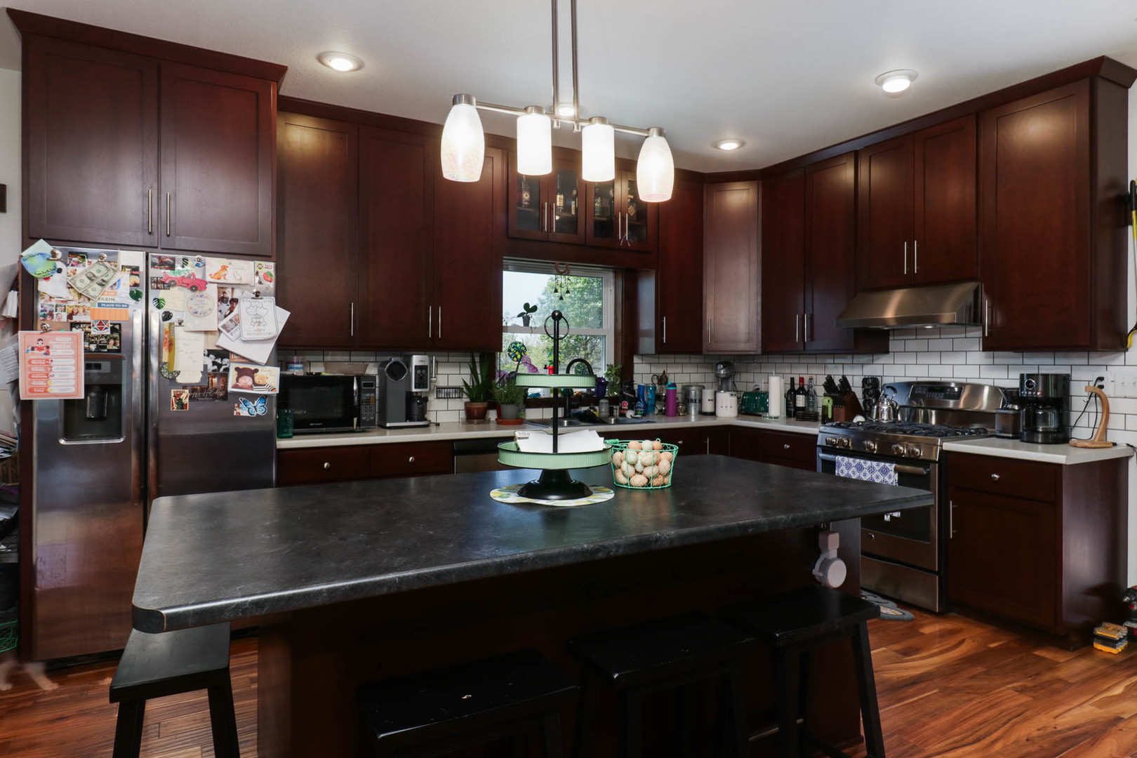 12014 Prairie Center Road Clinton, IL 61727 - Photo 9 of 56 a kitchen with stainless steel appliances granite countertop a sink a stove top oven a counter space and cabinets