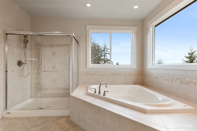 a white bath tub sitting next to a shower