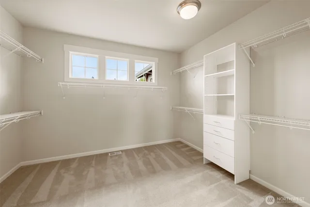 a view of an empty room with closet