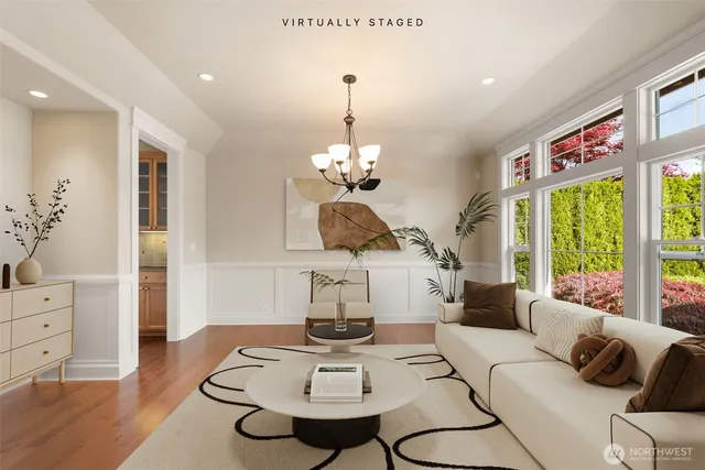 a living room with furniture a window and dining table