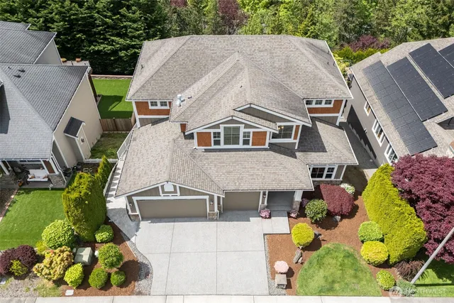 a aerial view of a house with a yard and potted plants