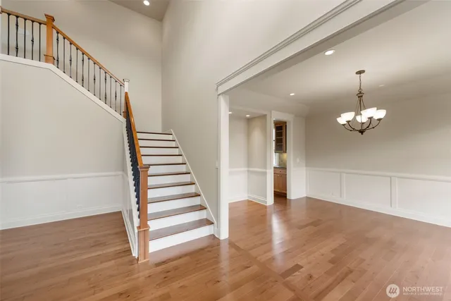 a view of a hallway with wooden floor and staircase