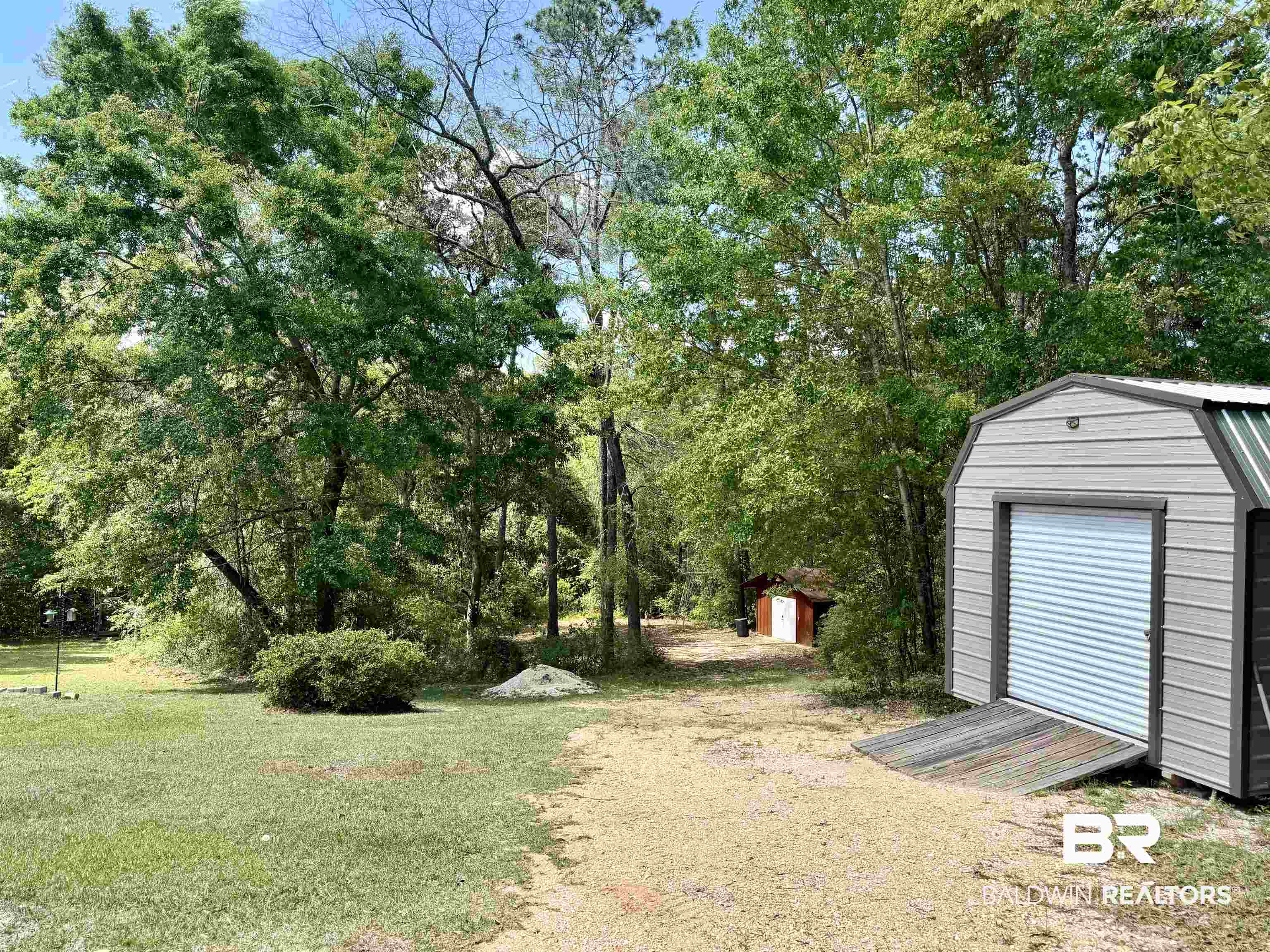 2944 Appleton Road Brewton, AL 36426 - Photo 58 of 65 View of grassy yard with a storage unit and view of wooded area