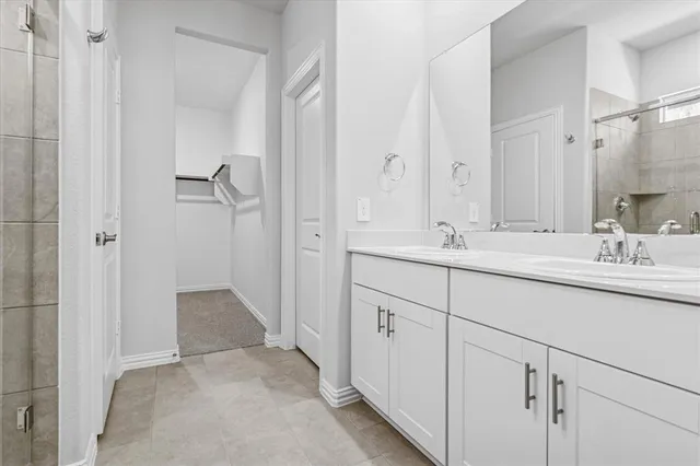 a bathroom with a double vanity sink mirror and