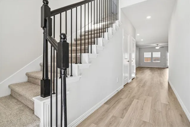 a view of hallway with wooden floor