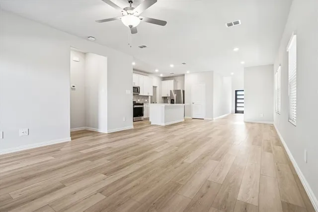 a view of a kitchen with a sink and a refrigerator