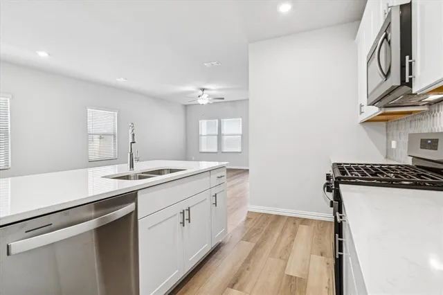 a kitchen with a sink stove and cabinets
