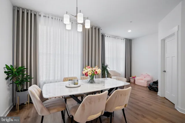 a view of a dining room with furniture window and wooden floor