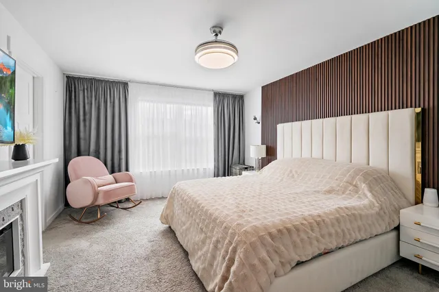 a spacious bedroom with a bed and a window