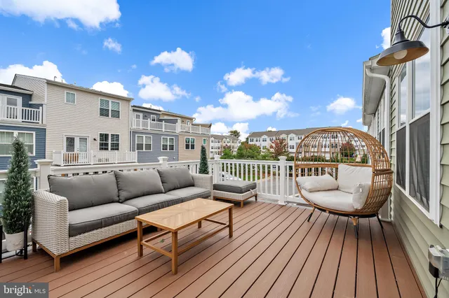 a balcony with furniture and wooden floor