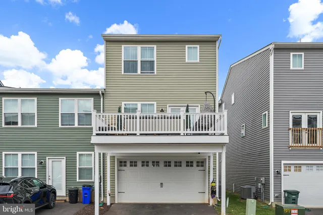 a view of a house with a balcony and large windows