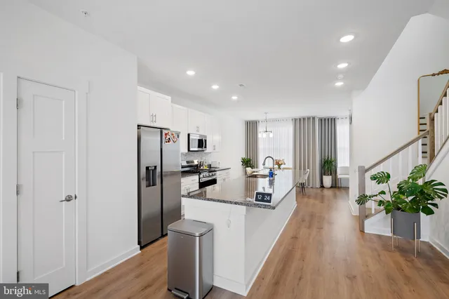 a view of a living room and entryway with wooden floor
