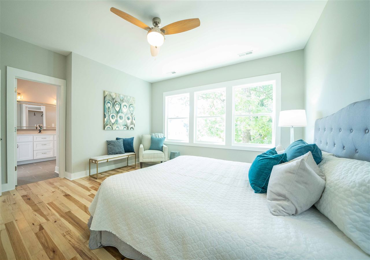 2318 Milburnie Road Raleigh, NC 27610 - Photo 12 of 28 a bedroom with a bed and a chandelier