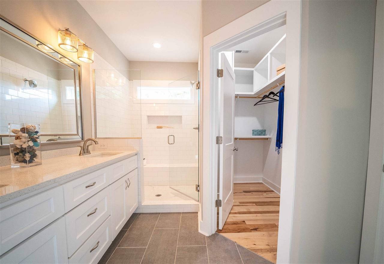 2318 Milburnie Road Raleigh, NC 27610 - Photo 13 of 28 a spacious bathroom with a shower sink and mirror