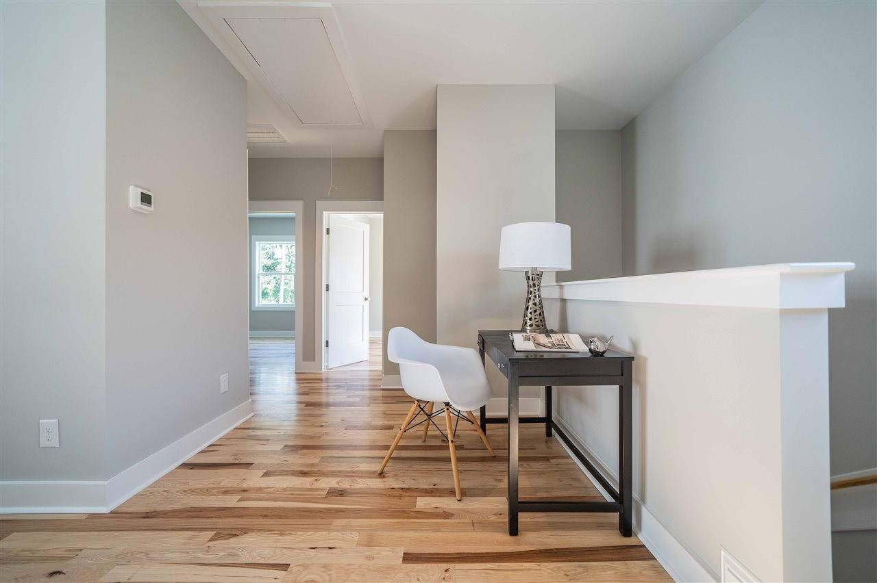 2318 Milburnie Road Raleigh, NC 27610 - Photo 14 of 28 a view of a room with wooden floor table and chairs