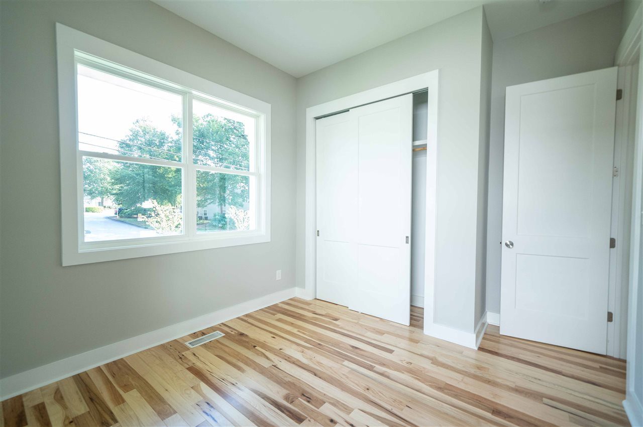 2318 Milburnie Road Raleigh, NC 27610 - Photo 23 of 28 a view of a room with wooden floor and window