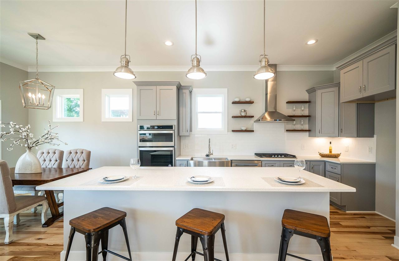 2318 Milburnie Road Raleigh, NC 27610 - Photo 3 of 28 a kitchen with stainless steel appliances a dining table and chairs