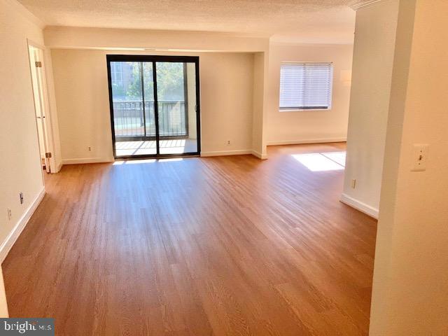 5902 Mt Eagle Drive, Unit 106 Alexandria, VA 22303 - Photo 13 of 73 an empty room with wooden floor and windows