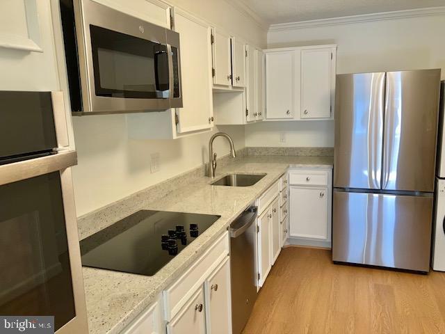 5902 Mt Eagle Drive, Unit 106 Alexandria, VA 22303 - Photo 18 of 73 a kitchen with a refrigerator sink and microwave