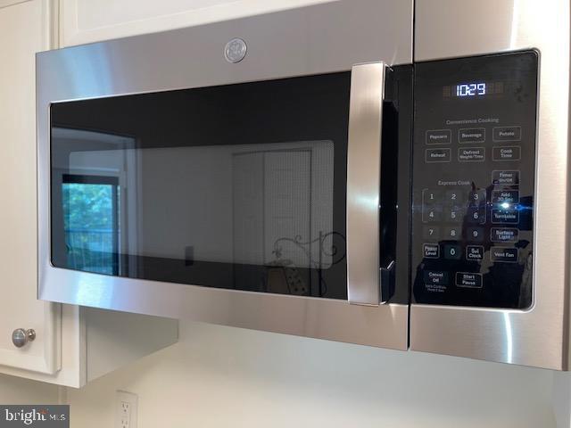 5902 Mt Eagle Drive, Unit 106 Alexandria, VA 22303 - Photo 21 of 73 Stainless steel GE microwave with fan over cooktop