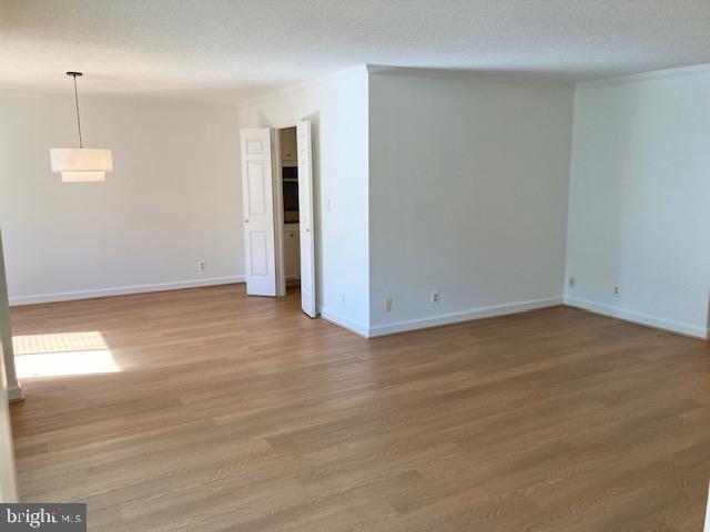 5902 Mt Eagle Drive, Unit 106 Alexandria, VA 22303 - Photo 30 of 73 an empty room with wooden floor and windows