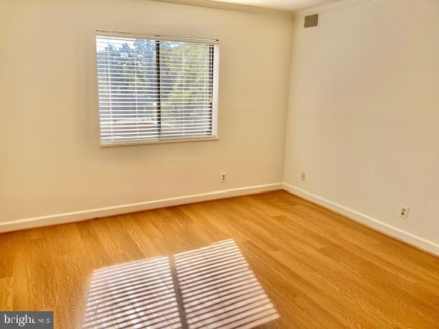 5902 Mt Eagle Drive, Unit 106 Alexandria, VA 22303 - Photo 33 of 73 a view of a room with wooden floor and a window