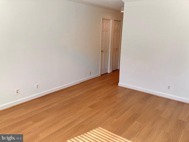 5902 Mt Eagle Drive, Unit 106 Alexandria, VA 22303 - Photo 35 of 73 an empty room with wooden floor