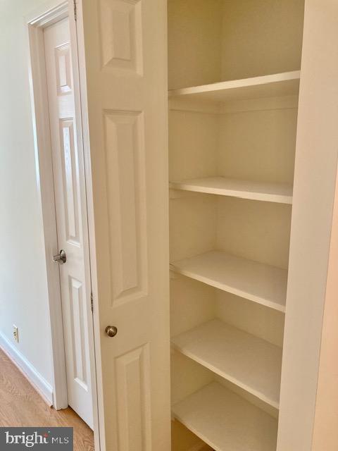 5902 Mt Eagle Drive, Unit 106 Alexandria, VA 22303 - Photo 38 of 73 a view of walk in closet with empty racks