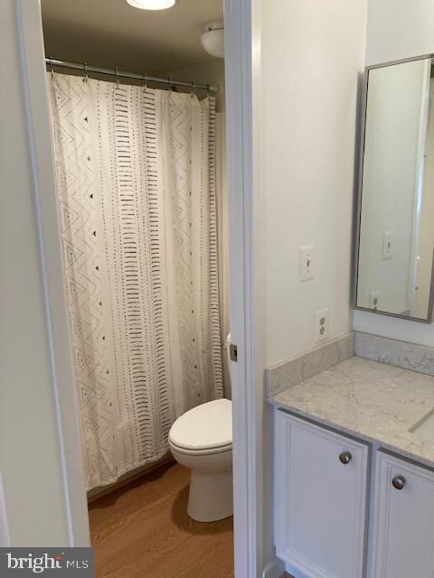 5902 Mt Eagle Drive, Unit 106 Alexandria, VA 22303 - Photo 42 of 73 a bathroom with a granite countertop sink toilet and shower