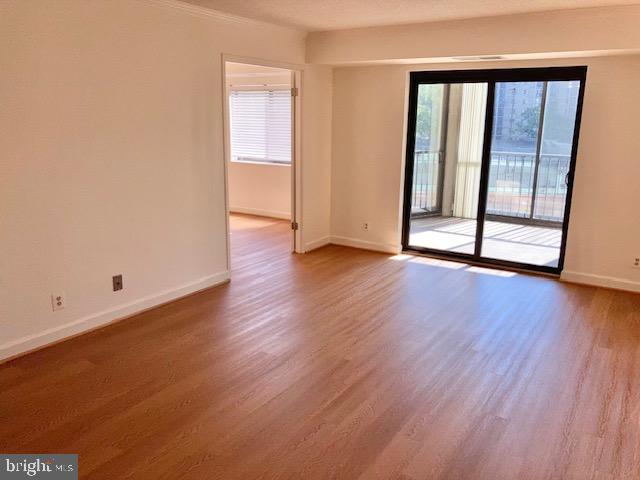 5902 Mt Eagle Drive, Unit 106 Alexandria, VA 22303 - Photo 44 of 73 a view of an empty room with wooden floor and a window