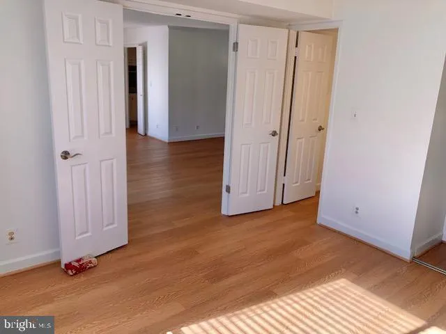 a view of a patio with table and chairs under an umbrella with wooden floor