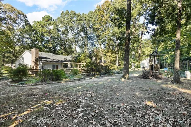 a view of a house with a tree in the background