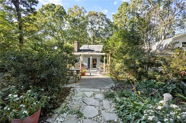 a front view of a house with a garden