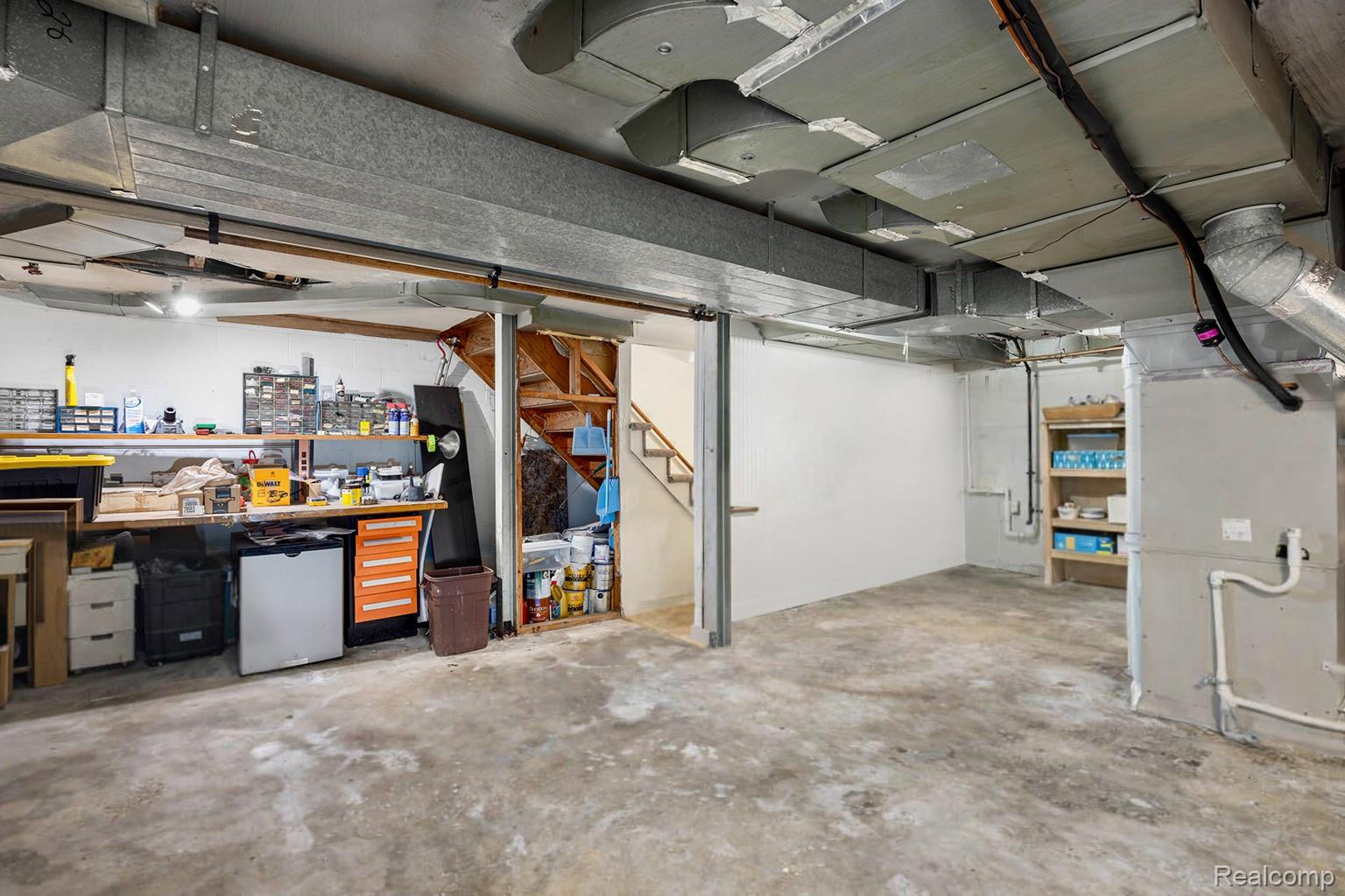 244 Kerby Road Grosse Pointe, MI 48236 - Photo 39 of 53 Below grade area featuring a workshop area and stainless steel refrigerator