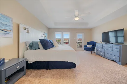 a spacious bedroom with a bed and dresser