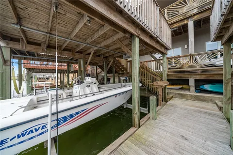 a view of a balcony with wooden floor and outdoor seating