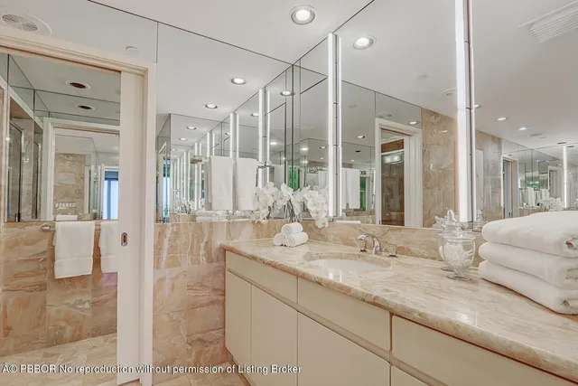 a bathroom with a granite countertop sink mirror and double