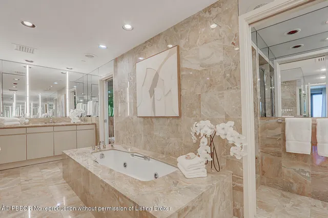 a bathroom with a large tub sink and vanity