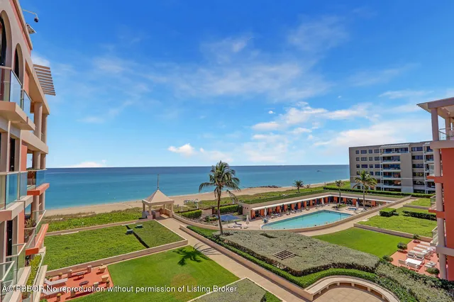 a view of a tennis ground with large trees